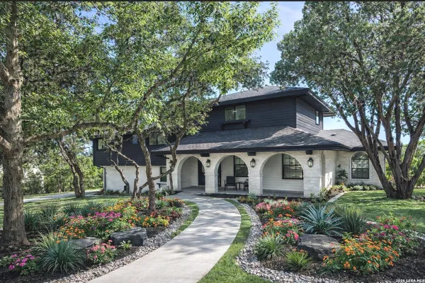 a front view of a house with a garden