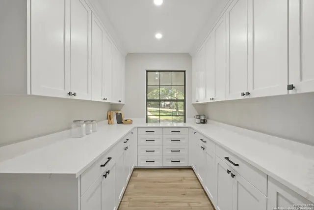 a kitchen with granite countertop white cabinets and white appliances