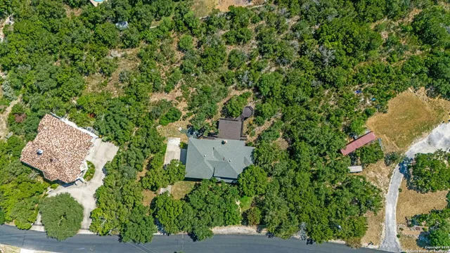 an aerial view of a house with a yard and outdoor seating