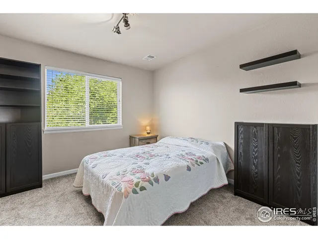 a bedroom with a bed a window and a closet