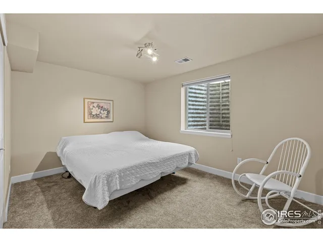 a bedroom with a bed and a chair