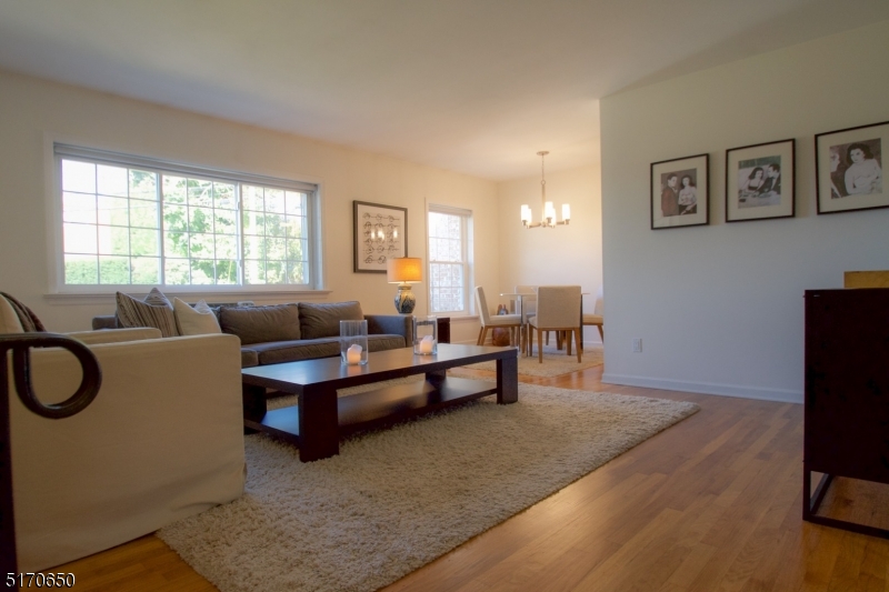 27 Corsa Terrace Ridgewood, NJ 07450 - Photo 2 of 10 a living room with furniture a flat screen tv and a window