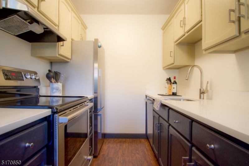 27 Corsa Terrace Ridgewood, NJ 07450 - Photo 5 of 10 a kitchen with stainless steel appliances a sink a stove and a refrigerator