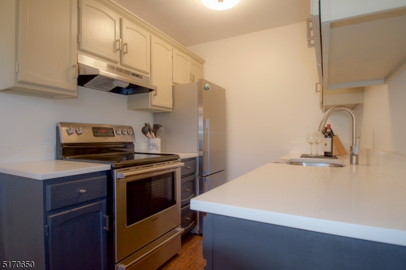 27 Corsa Terrace Ridgewood, NJ 07450 - Photo 6 of 10 a kitchen with stainless steel appliances granite countertop a stove a sink and a refrigerator