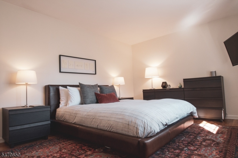 27 Corsa Terrace Ridgewood, NJ 07450 - Photo 9 of 10 a bedroom with a bed and lamp