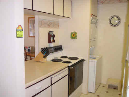 1763 Pe'e Road, Unit 304 Koloa, HI 96756 - Photo 7 of 14 a kitchen with a sink and a stove top oven