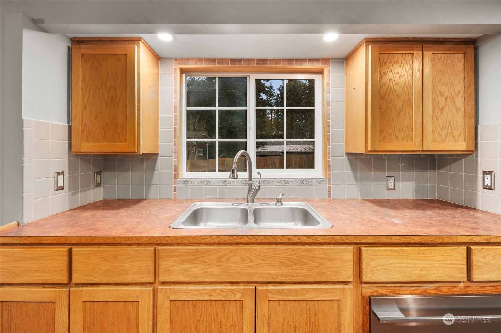 15832 Southeast 144th Street Renton, WA 98059 - Photo 16 of 40 a kitchen with granite countertop sink and window