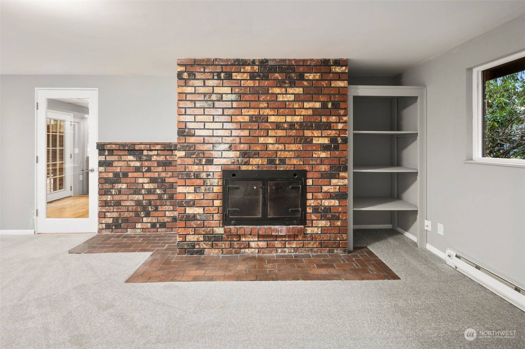 15832 Southeast 144th Street Renton, WA 98059 - Photo 21 of 40 a room with a fireplace and a large window