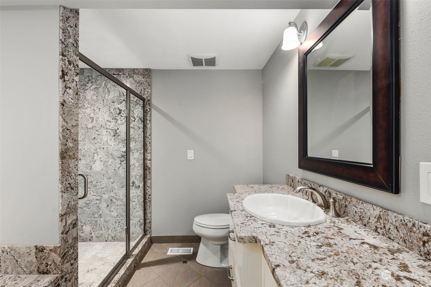 15832 Southeast 144th Street Renton, WA 98059 - Photo 32 of 40 a bathroom with a granite countertop sink toilet and shower