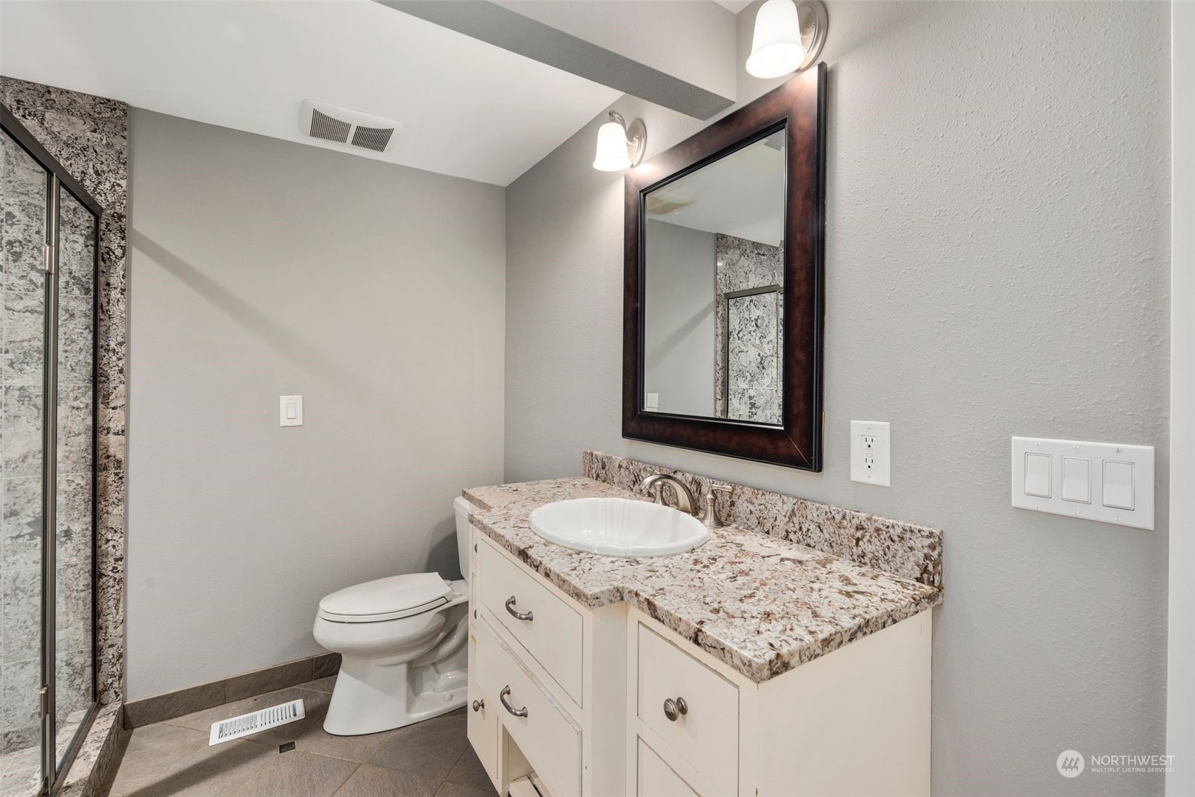 15832 Southeast 144th Street Renton, WA 98059 - Photo 33 of 40 a bathroom with a granite countertop sink toilet and mirror