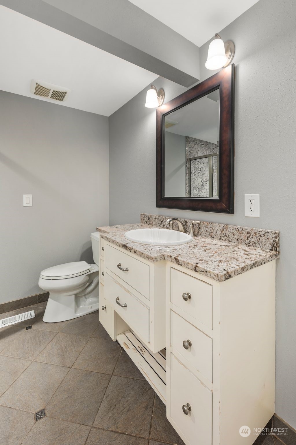 15832 Southeast 144th Street Renton, WA 98059 - Photo 34 of 40 a bathroom with a granite countertop toilet sink and mirror
