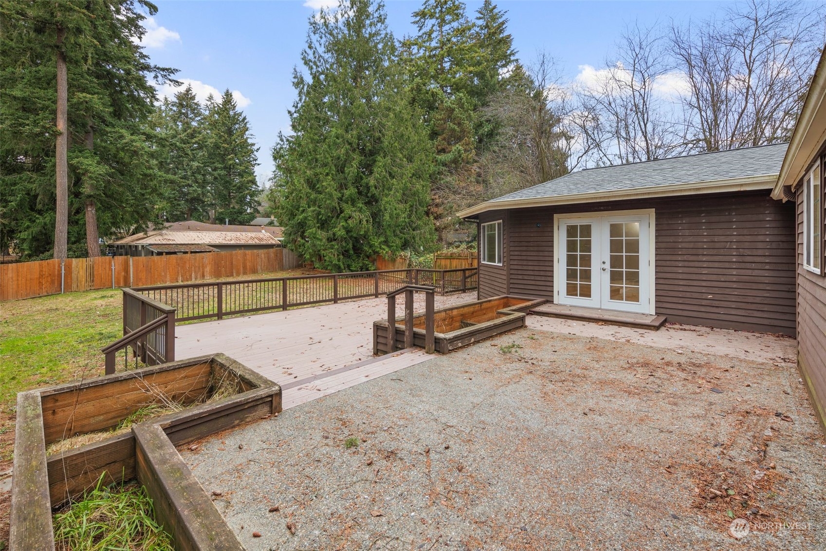 15832 Southeast 144th Street Renton, WA 98059 - Photo 5 of 40 a view of a backyard with a large tree and wooden fence