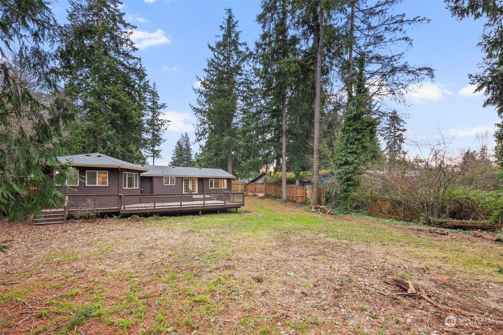 15832 Southeast 144th Street Renton, WA 98059 - Photo 8 of 40 a view of a house with a yard and large trees
