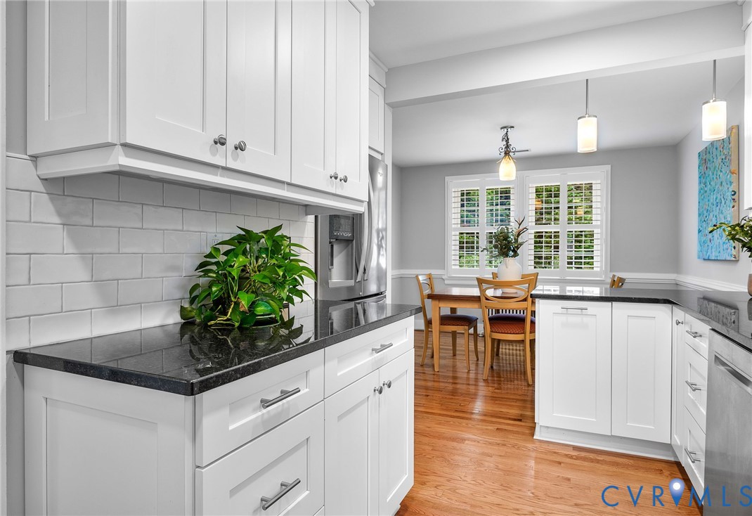1100 Skipwith Road Henrico, VA 23229 - Photo 11 of 34 a kitchen with white cabinets and chandelier