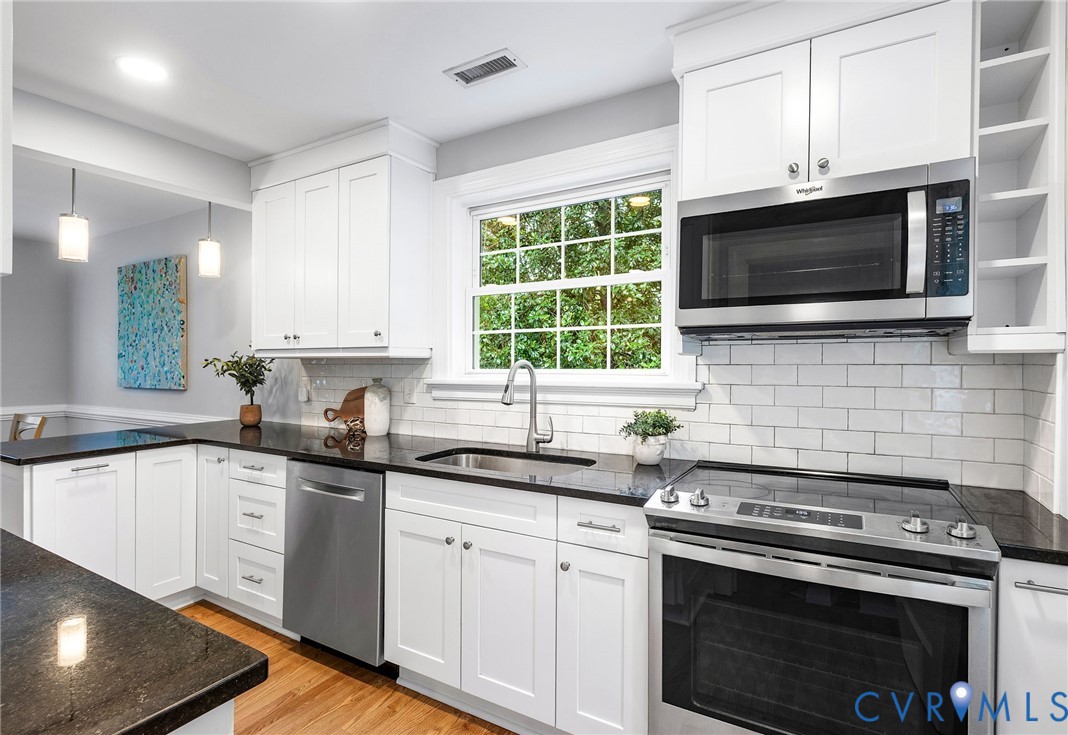 1100 Skipwith Road Henrico, VA 23229 - Photo 10 of 34 a kitchen with stainless steel appliances a stove a sink a stove a microwave and cabinets