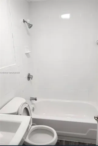 a bathroom with a toilet and a bathtub