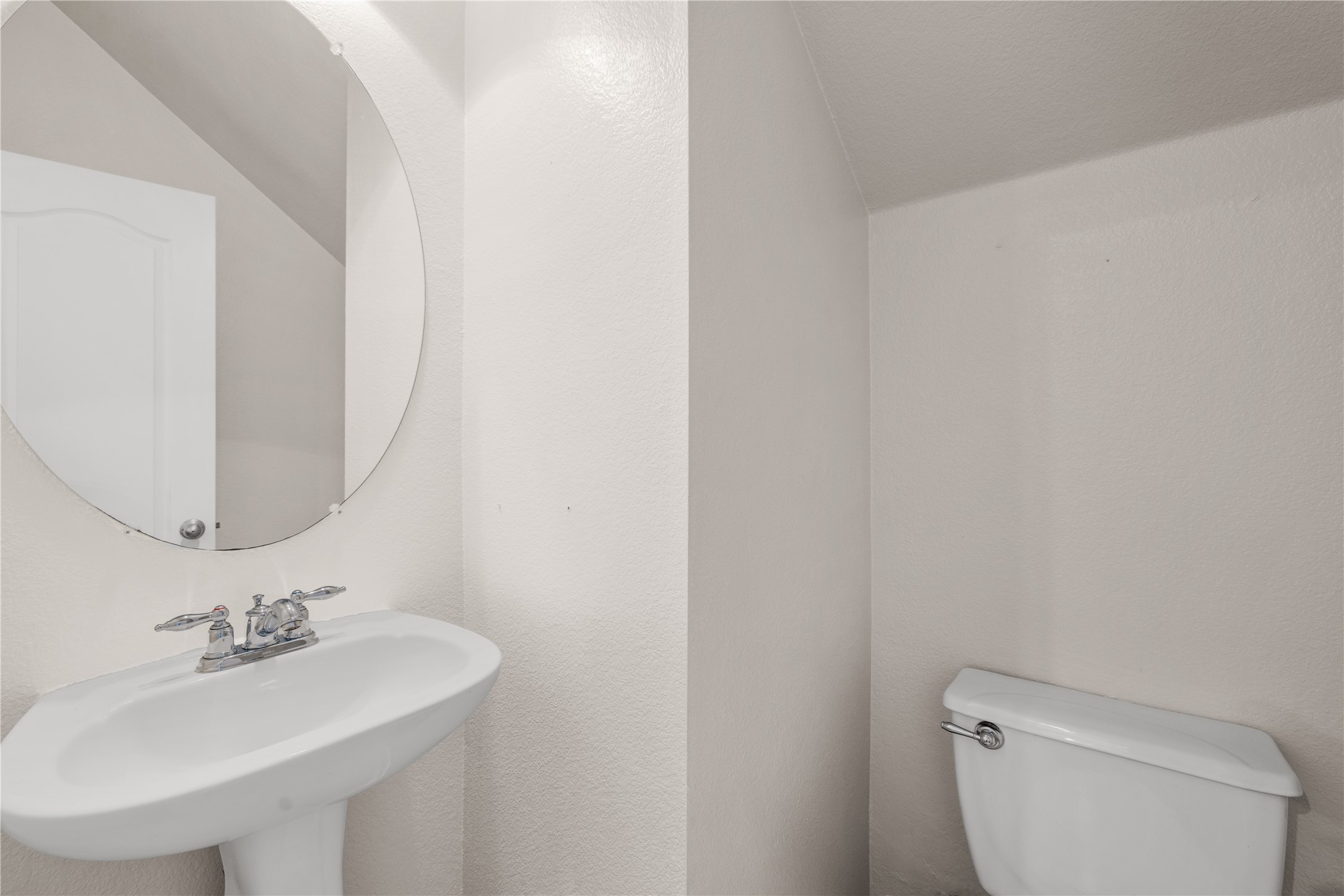 11000 Anderson Mill Road, Unit 45 Austin, TX 78750 - Photo 20 of 32 a bathroom with a sink a toilet and mirror
