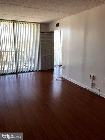 a view of a room with wooden floor