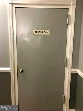 a front view of an apartment building with a yard