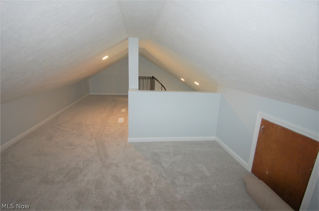 1299 State Road Vermilion, OH 44089 - Photo 26 of 36 Additional loft space with a textured ceiling, carpet flooring