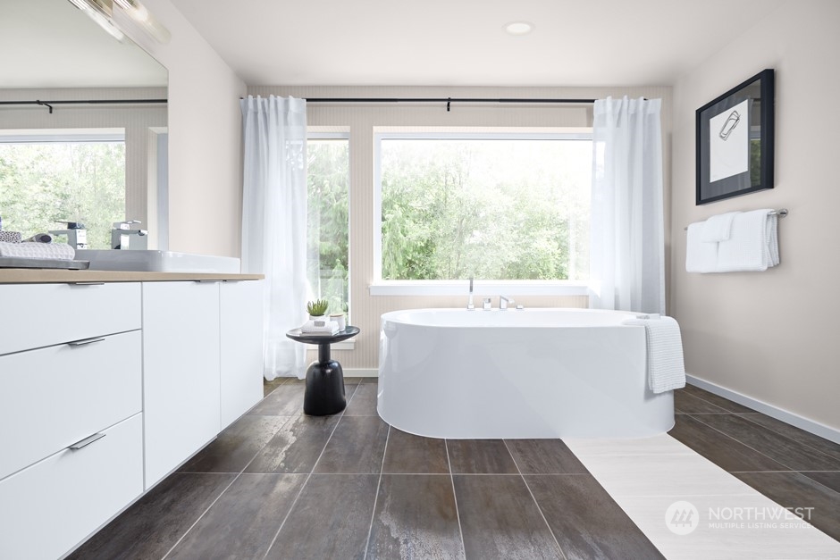 16040 Southeast 252 Place Covington, WA 98042 - Photo 10 of 11 a white bath tub sitting in a bathroom next to a window