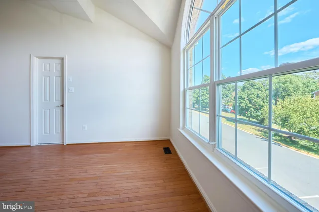 a bathroom with a sink a toilet a window and shower