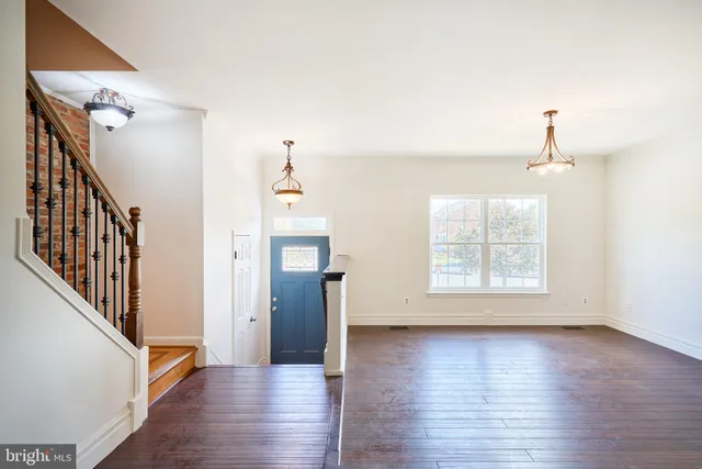 wooden floor in an empty room with a window and wooden floor