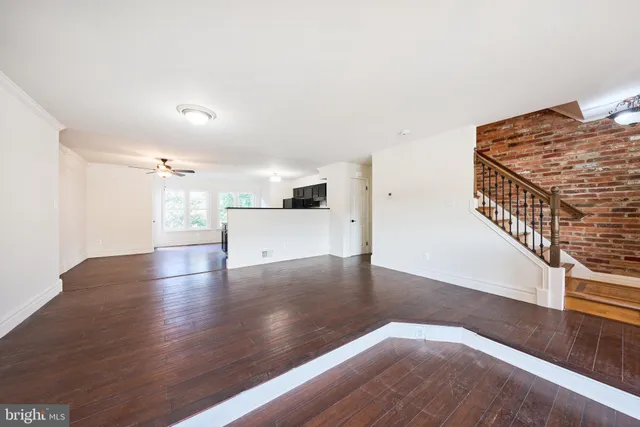 a kitchen with stainless steel appliances granite countertop a stove a sink dishwasher a refrigerator and a microwave oven with wooden floor