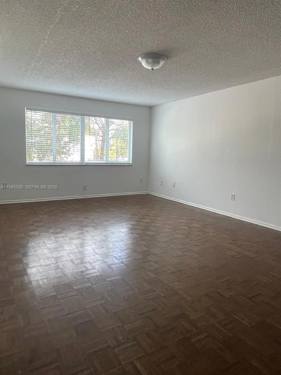 14830 Naranja Lakes Boulevard, Unit A2Q Homestead, FL 33032 - Photo 2 of 8 an empty room with wooden floor and windows