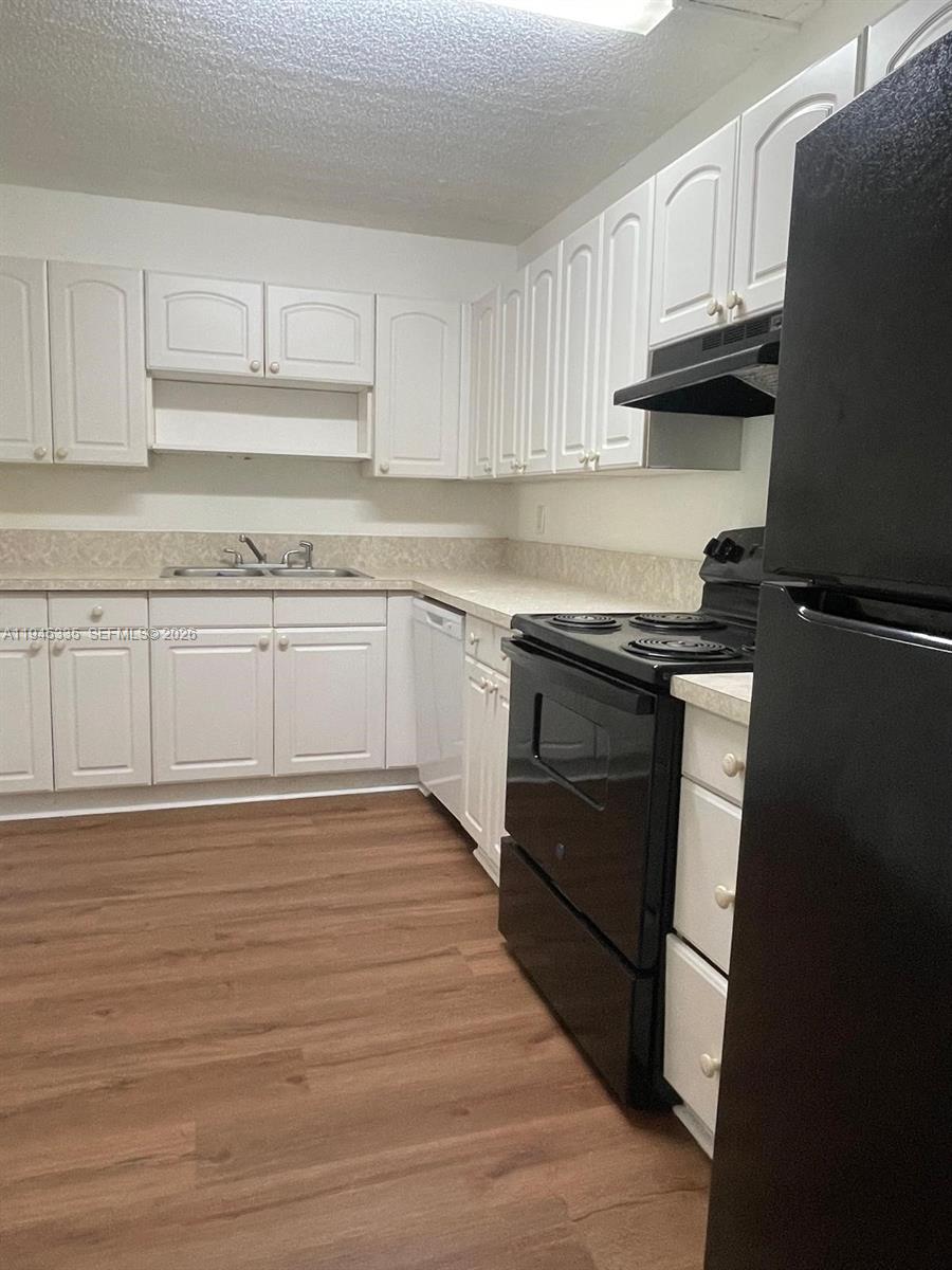 14830 Naranja Lakes Boulevard, Unit A2Q Homestead, FL 33032 - Photo 3 of 8 a kitchen with granite countertop a stove top oven sink and cabinets