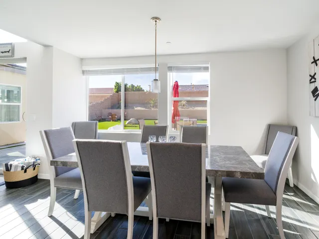 a large white kitchen with a table and chairs