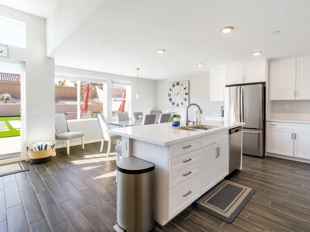 a kitchen with stainless steel appliances a refrigerator stove microwave and white cabinets