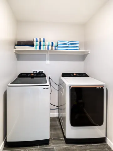 a bedroom with a bed a flat screen tv and dresser