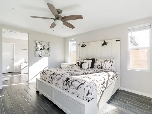 a room with a bed and a view of living room