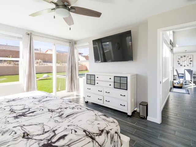 a bedroom with a bed and a chandelier