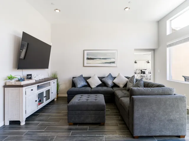 a kitchen with stainless steel appliances a dining table chairs microwave and sink