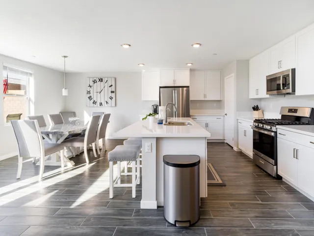 a dining room with furniture a rug and wooden floor