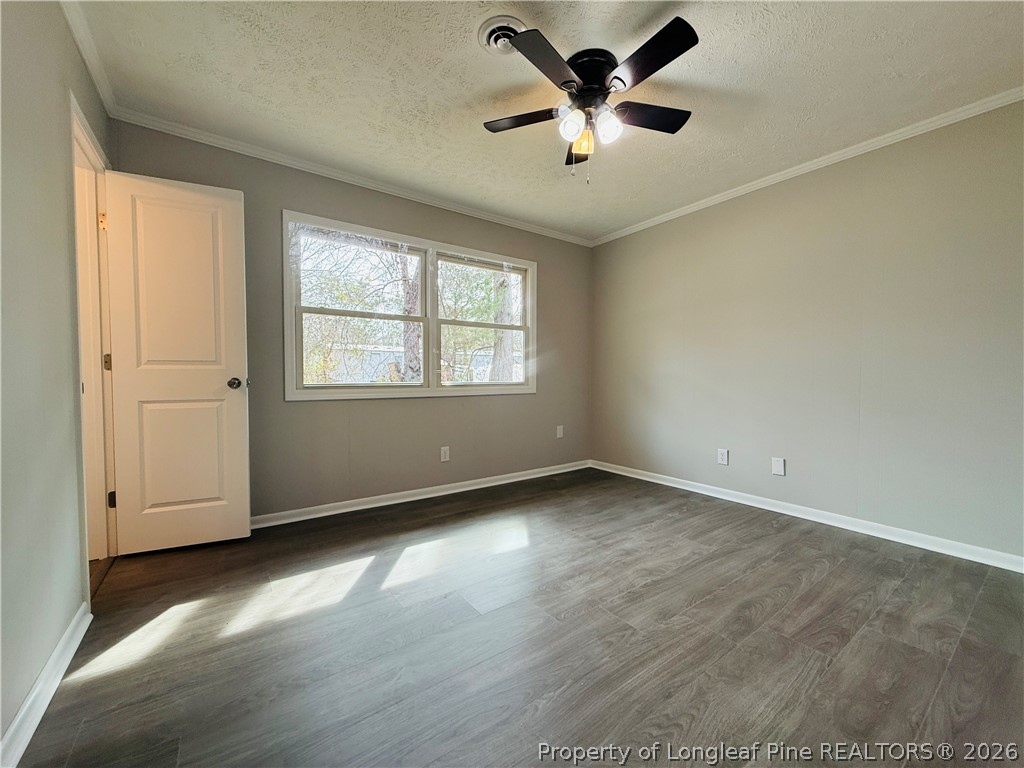 4736 Rosehill Road Fayetteville, NC 28311 - Photo 7 of 15 an empty room with wooden floor and windows