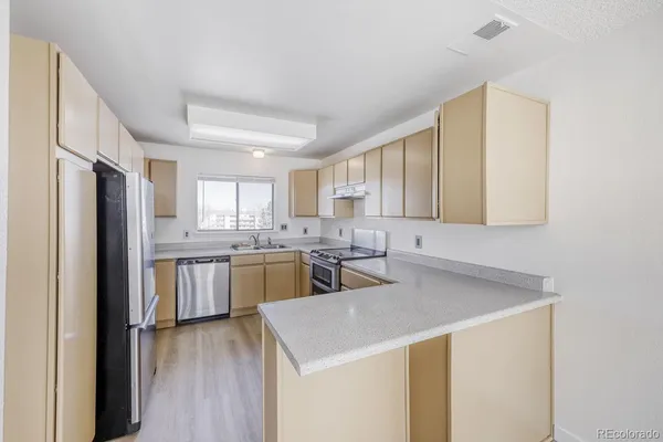 a kitchen with a sink a stove and refrigerator
