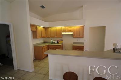 11870 Shawnee Road Fort Myers, FL 33913 - Photo 10 of 10 a kitchen with stainless steel appliances granite countertop a sink and a refrigerator