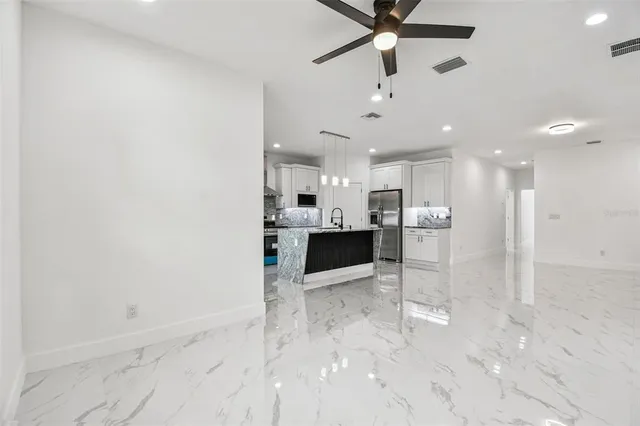 a view of a kitchen with a sink and cabinets