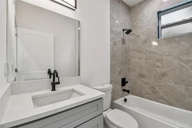 a bathroom with a sink a toilet and a bathtub