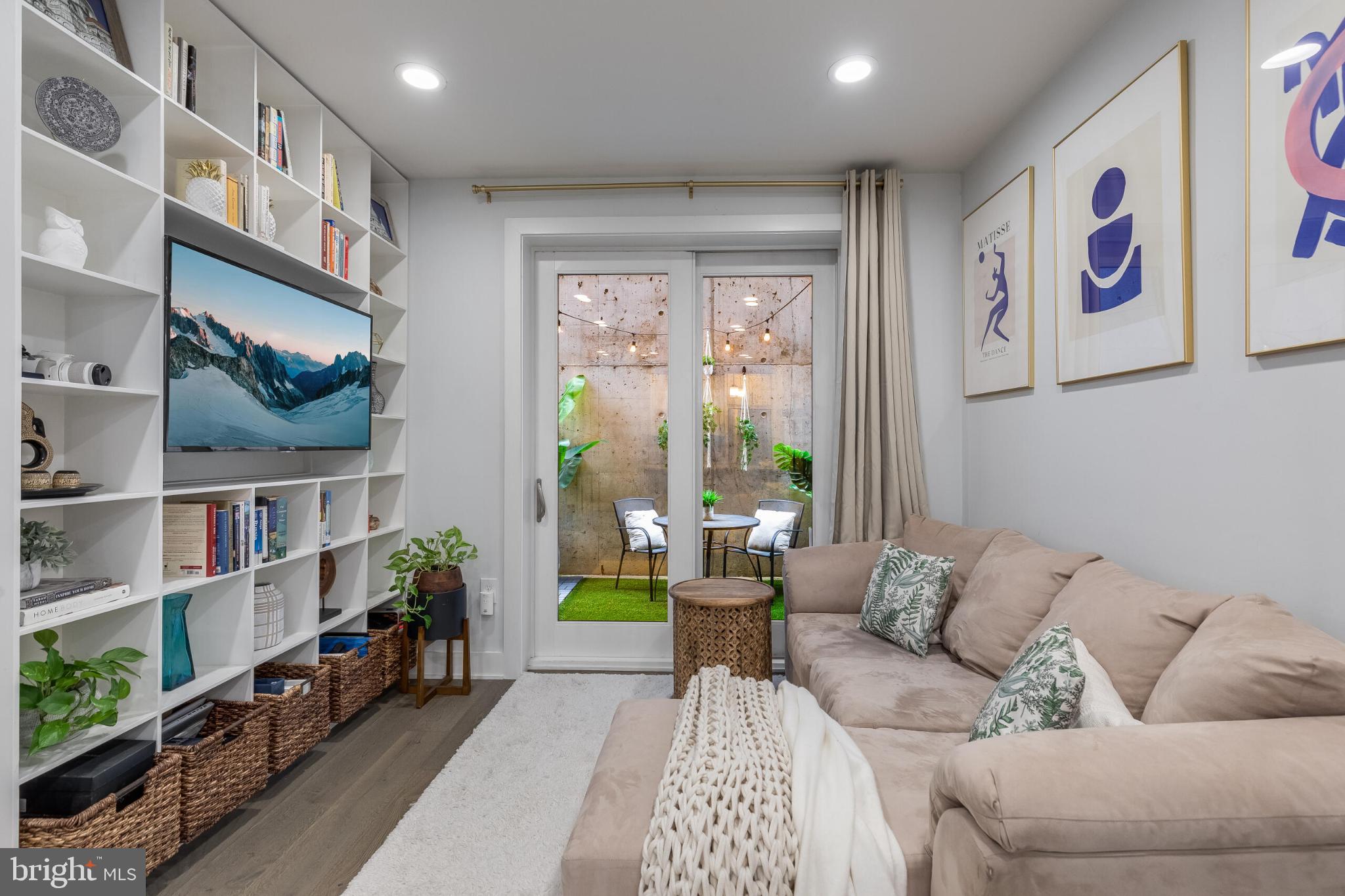 1412 Chapin Street Northwest, Unit 5 Washington, DC 20009 - Photo 11 of 23 a living room with furniture a bookshelf and a window