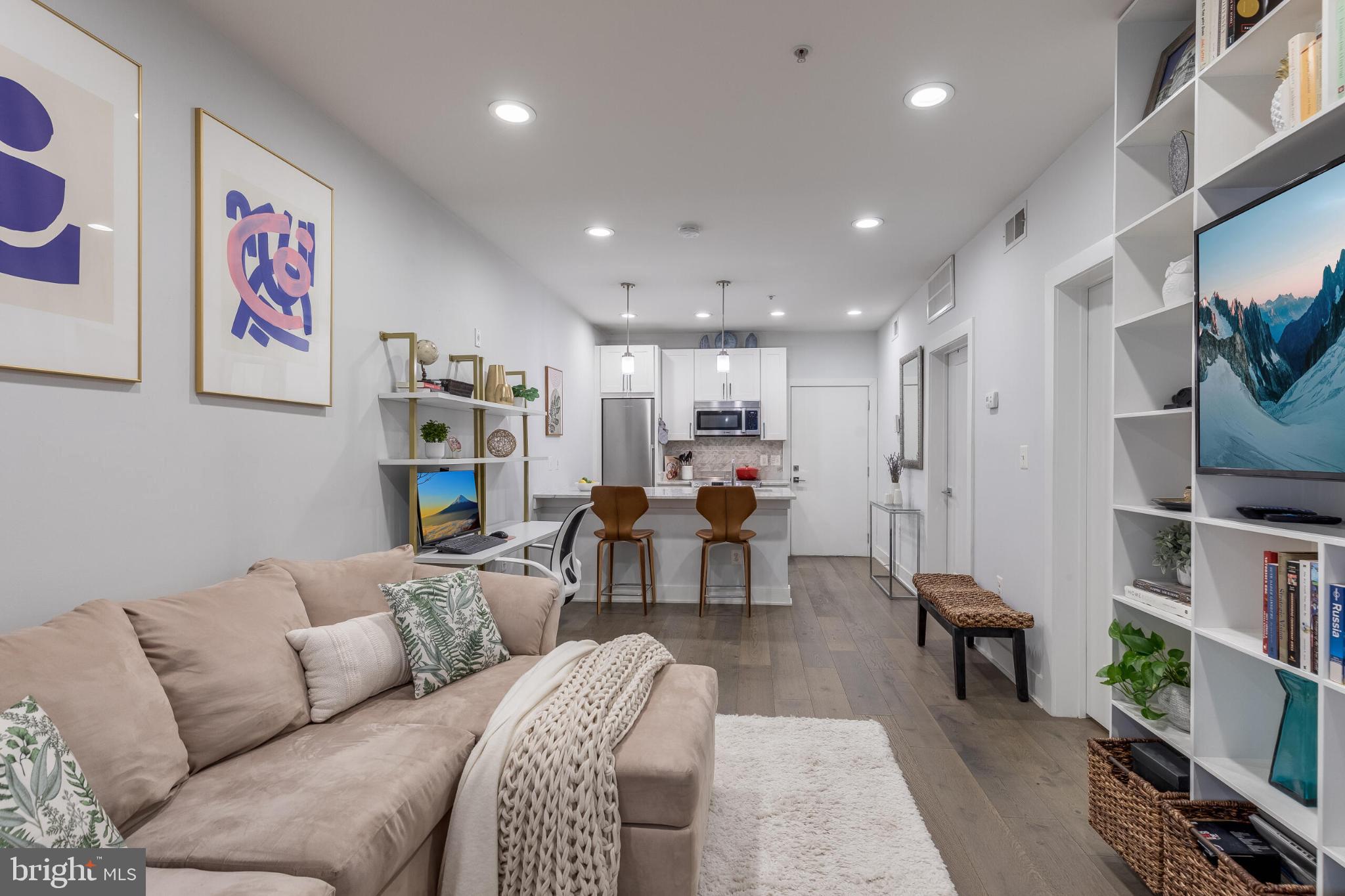 1412 Chapin Street Northwest, Unit 5 Washington, DC 20009 - Photo 2 of 23 a living room with furniture and a flat screen tv