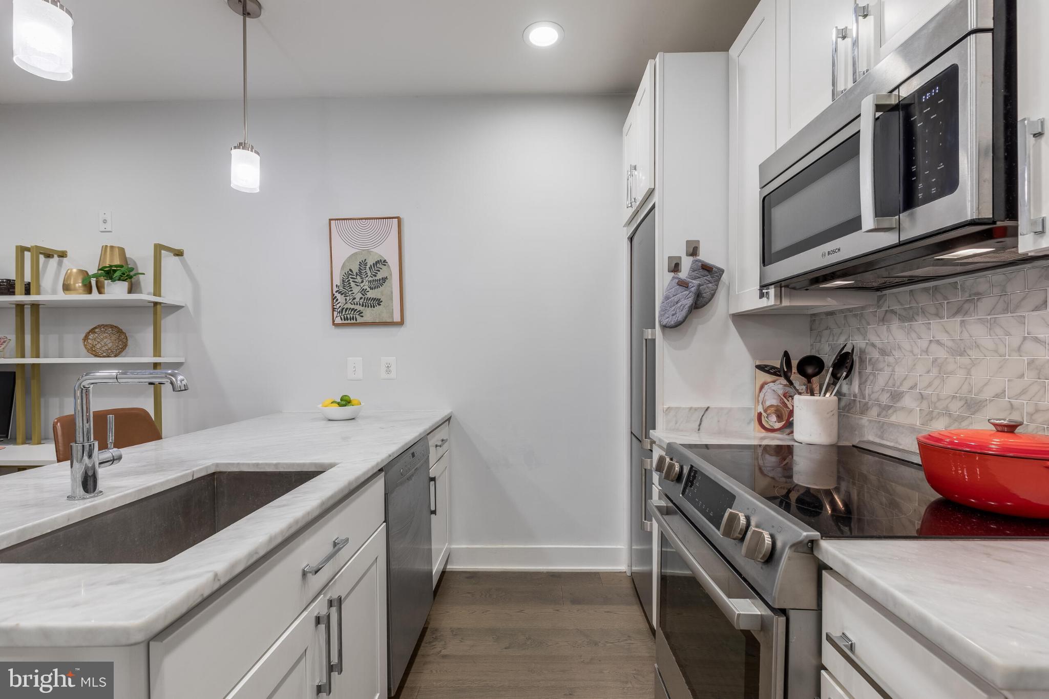 1412 Chapin Street Northwest, Unit 5 Washington, DC 20009 - Photo 4 of 23 a kitchen with stainless steel appliances a sink stove and cabinets