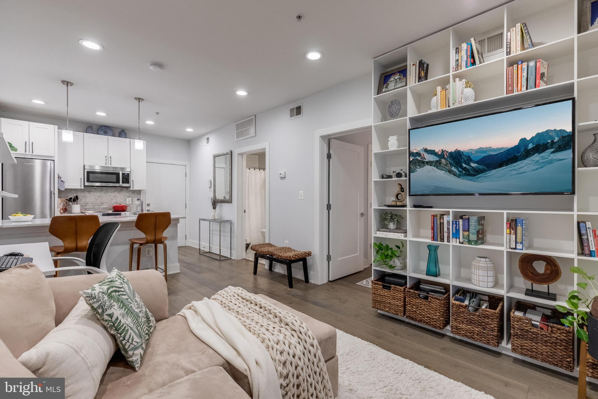 1412 Chapin Street Northwest, Unit 5 Washington, DC 20009 - Photo 10 of 23 a living room with furniture a flat screen tv and a book shelf