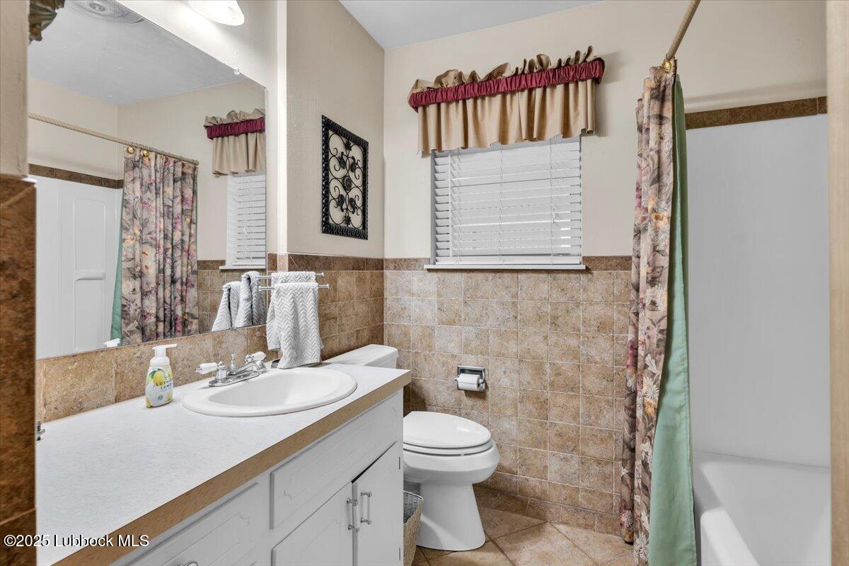 1405 3rd Street Plains, TX 79355 - Photo 11 of 19 a bathroom with a sink toilet and shower
