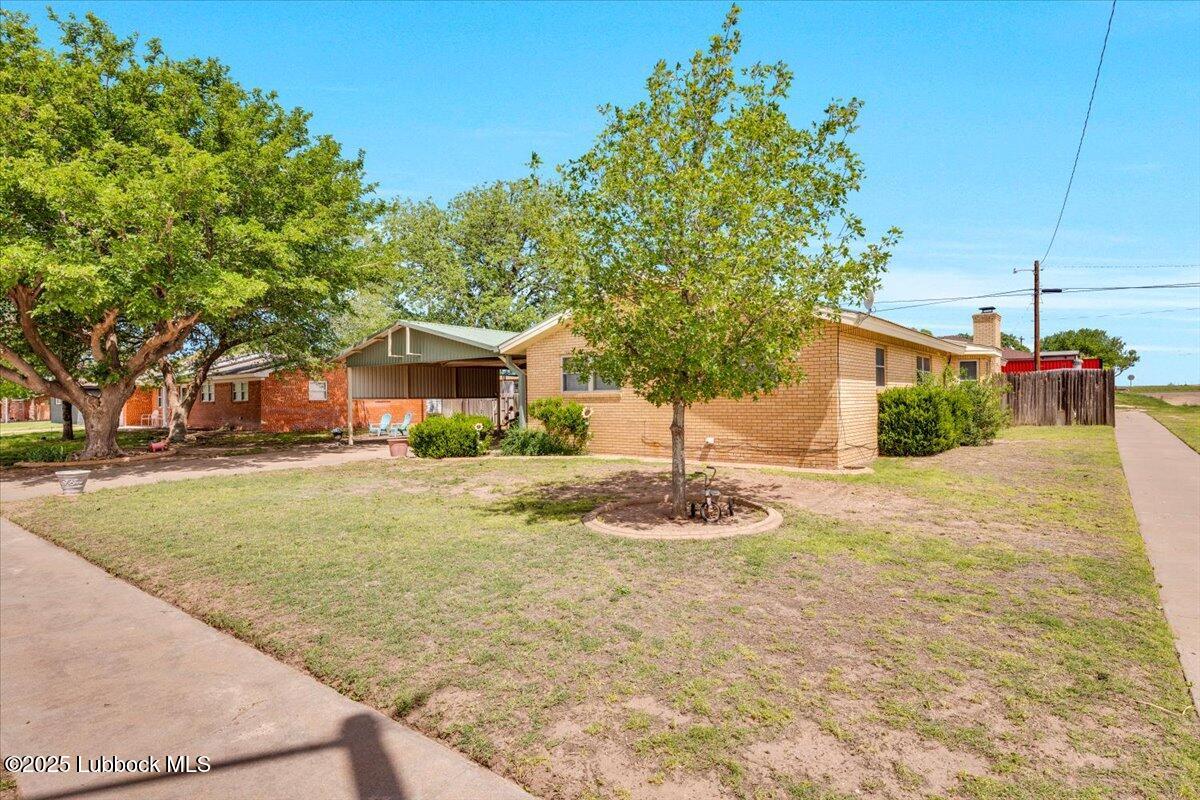 1405 3rd Street Plains, TX 79355 - Photo 14 of 19 a front view of a house with a yard