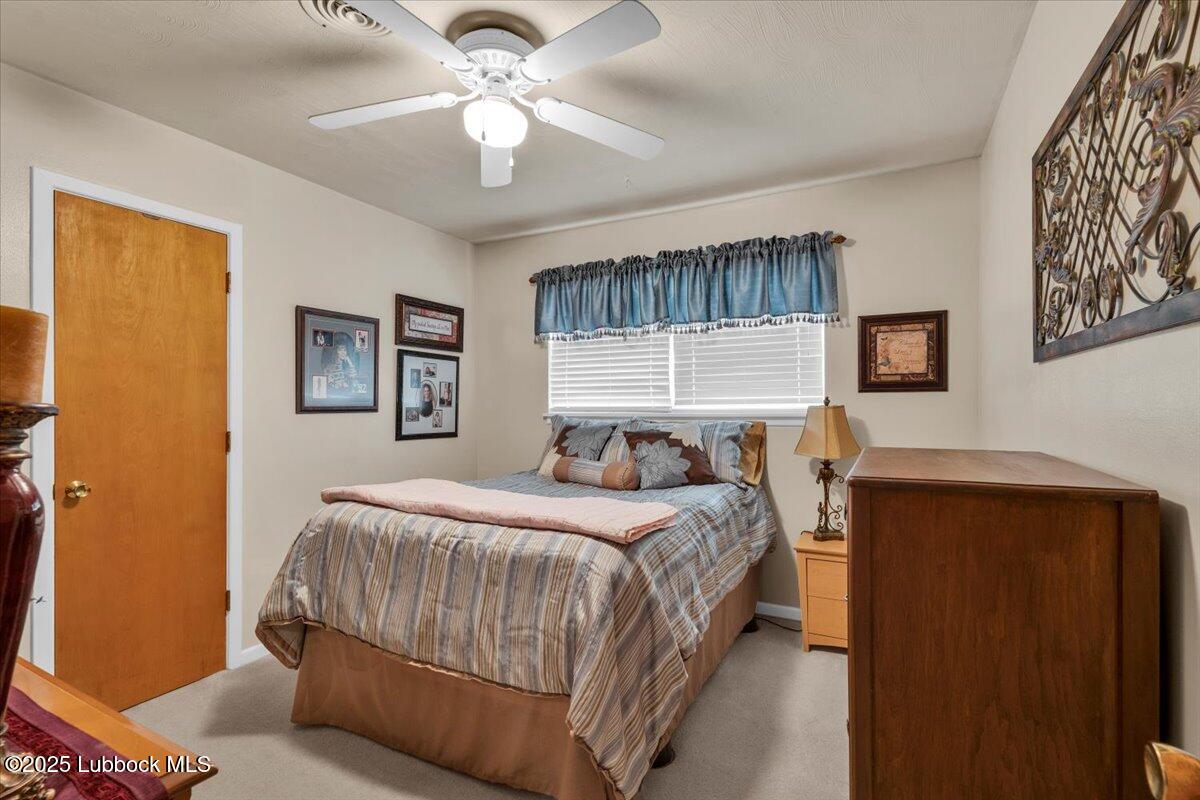 1405 3rd Street Plains, TX 79355 - Photo 15 of 19 a bedroom with a bed chandelier and a window