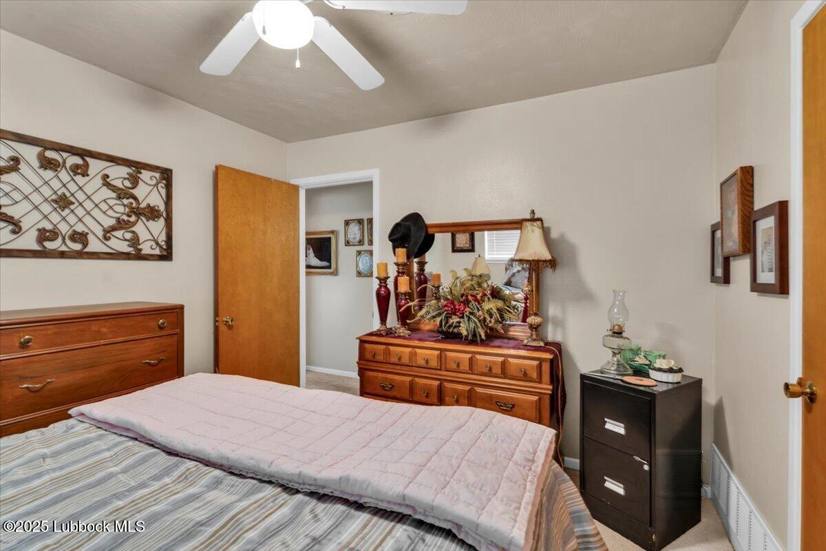 1405 3rd Street Plains, TX 79355 - Photo 17 of 19 a bedroom with a bed and cabinets